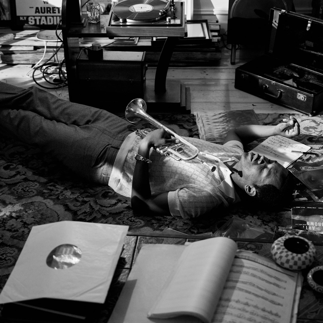 Grayscale photo of same musician laying on the floor